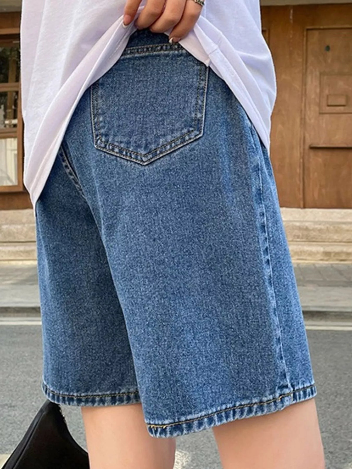 High-Waisted Loose Fit Denim Shorts, back view in blue