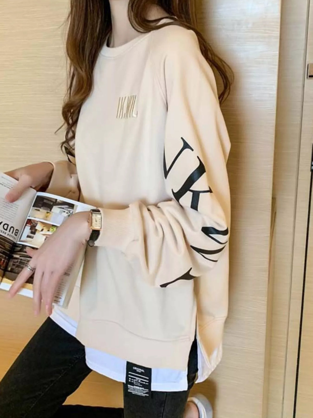 Apricot layered-hem sweatshirt with graphic sleeve detail