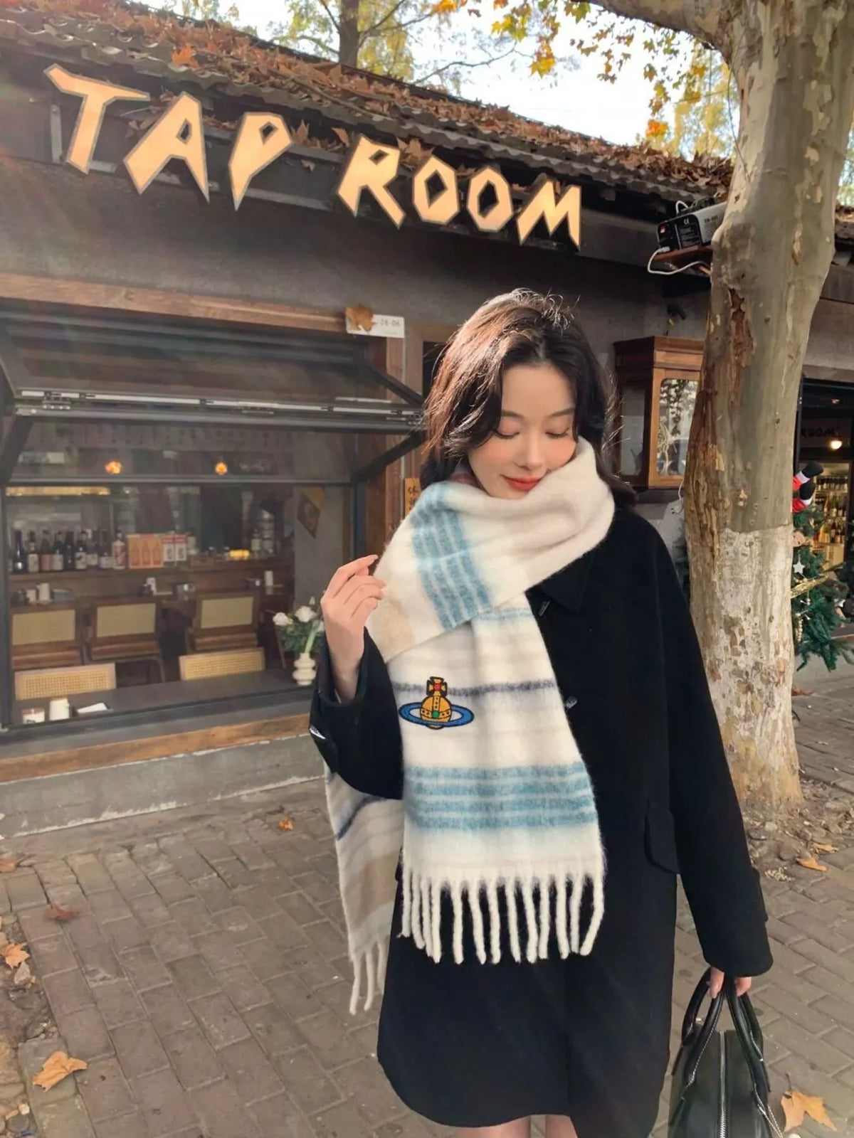 Embroidered Orb Logo Plaid Scarf, shown worn