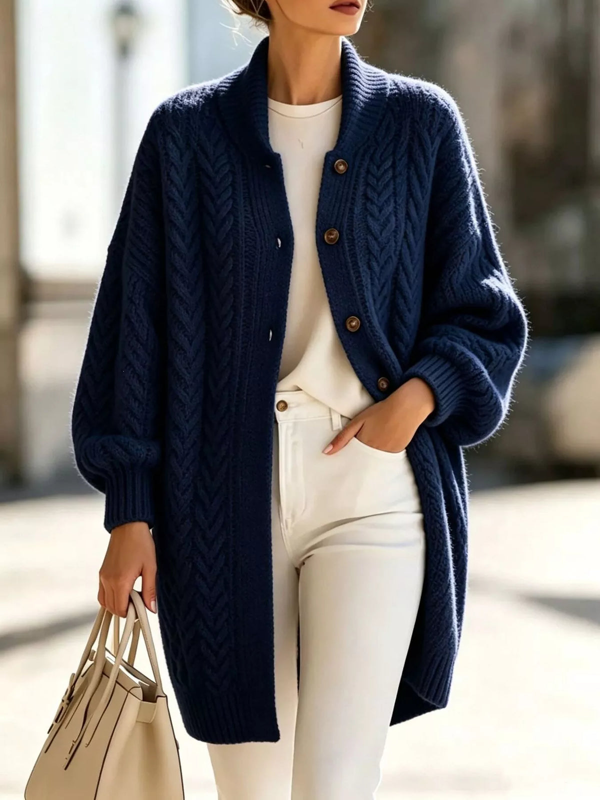 Navy longline cable-knit button-front cardigan, front view.