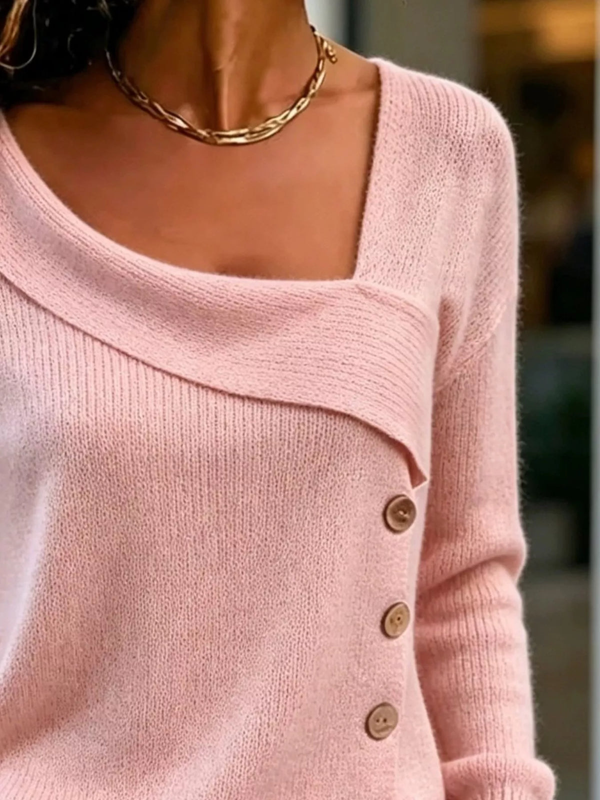 Women's Asymmetric Neckline Button-Decorated Sweater in pink — neckline detail view