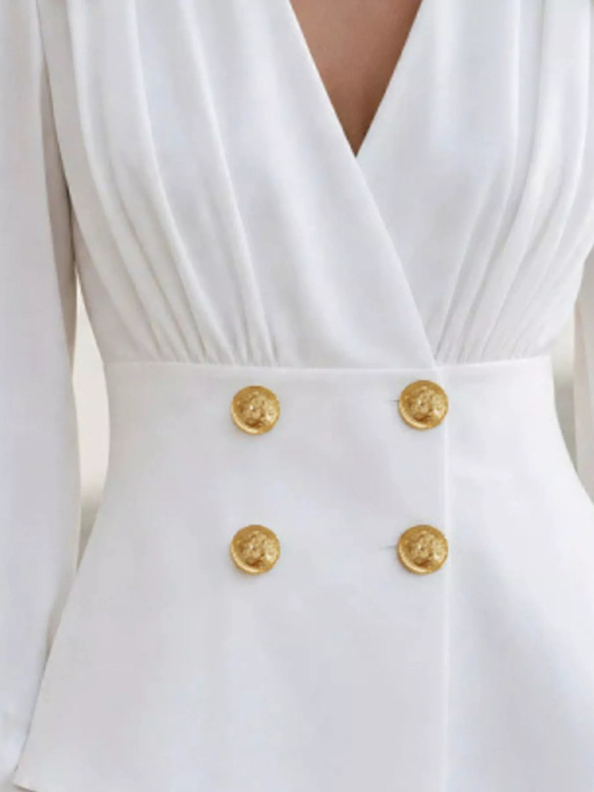Double-breasted peplum blouse in white, waist and button detail