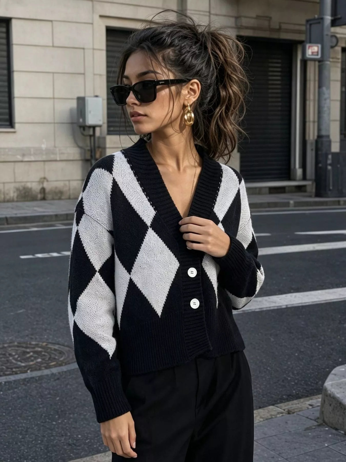 Black and white argyle v-neck button-front cardigan, standing front view.