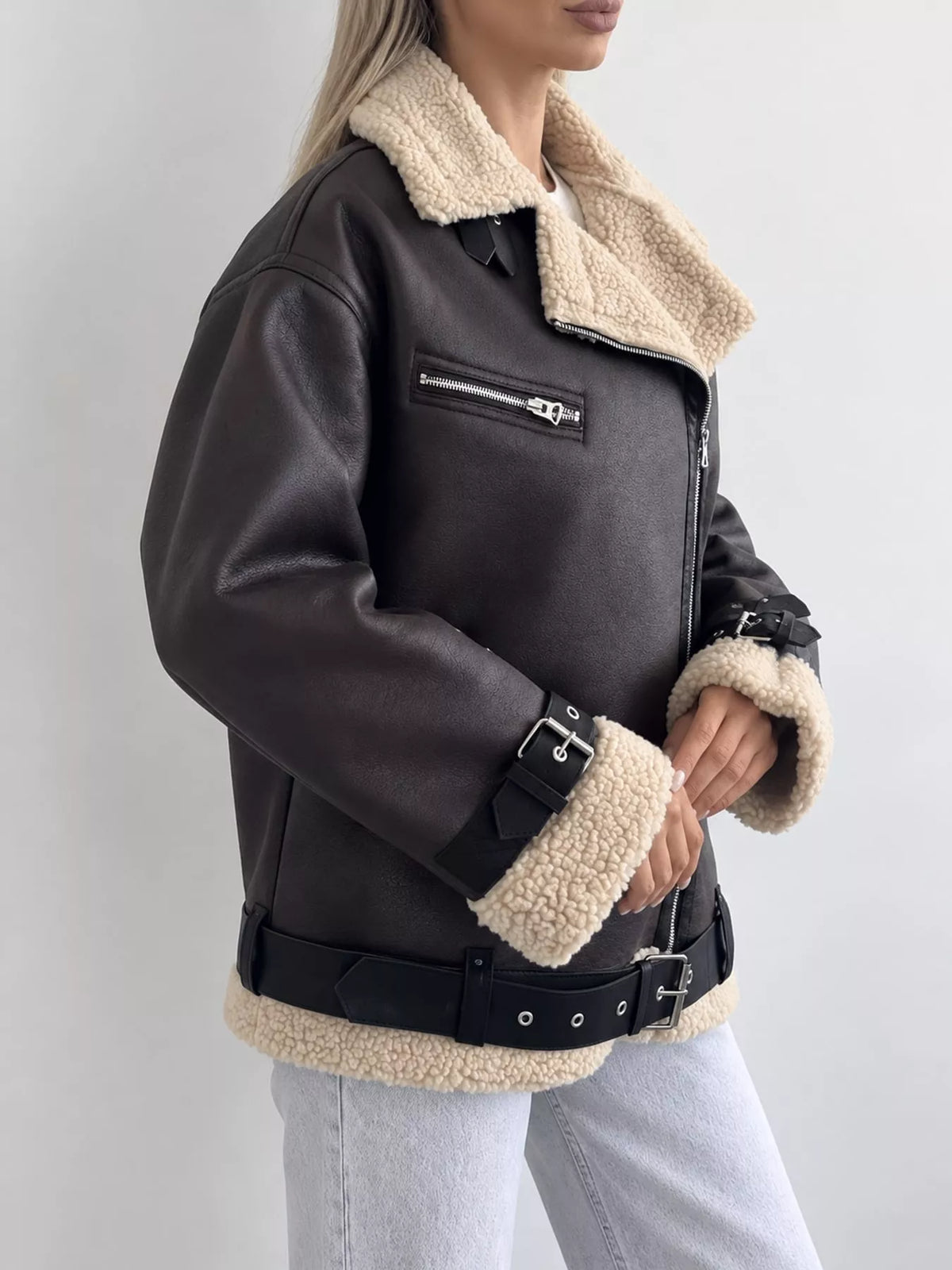 Black with cream trim faux leather zip up jacket, side view