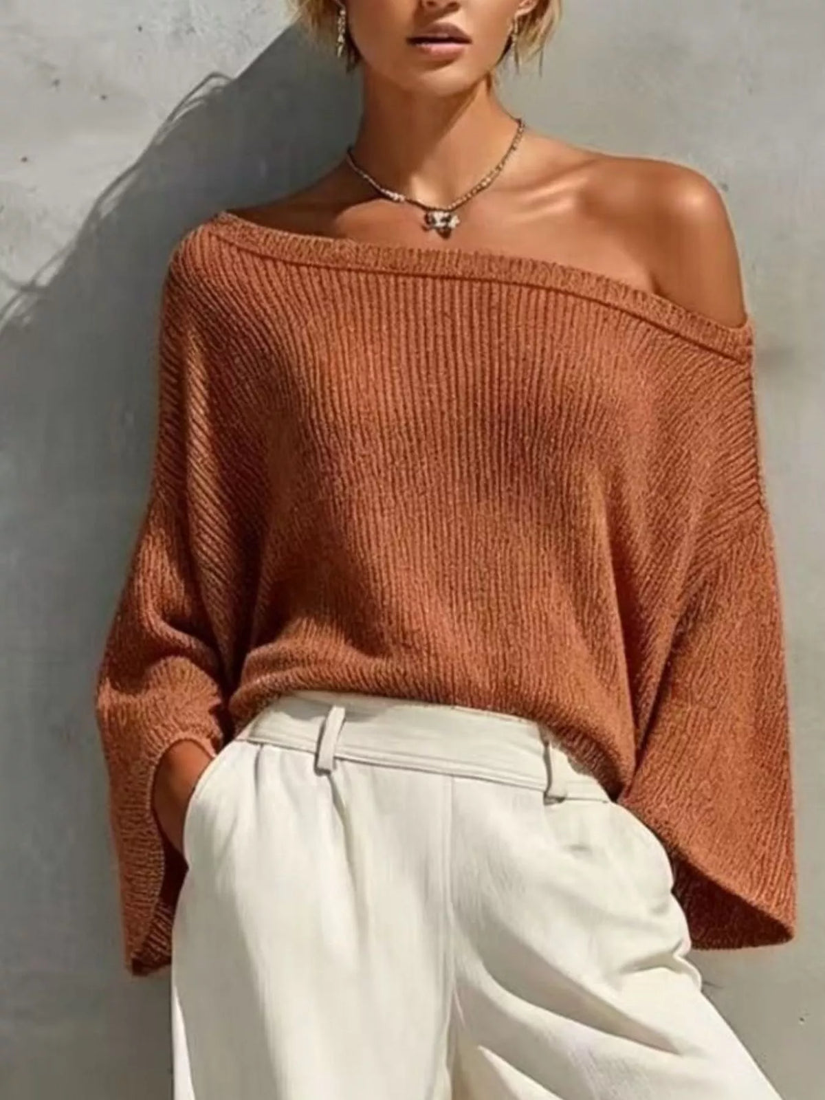 Rust one-shoulder knit top and pants set, knit top neckline detail.