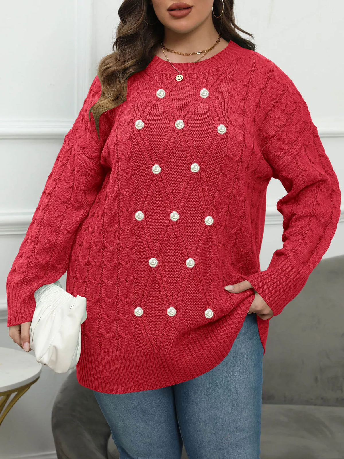 Red plus-size cable-knit sweater with pearl-like front accents, angled front view