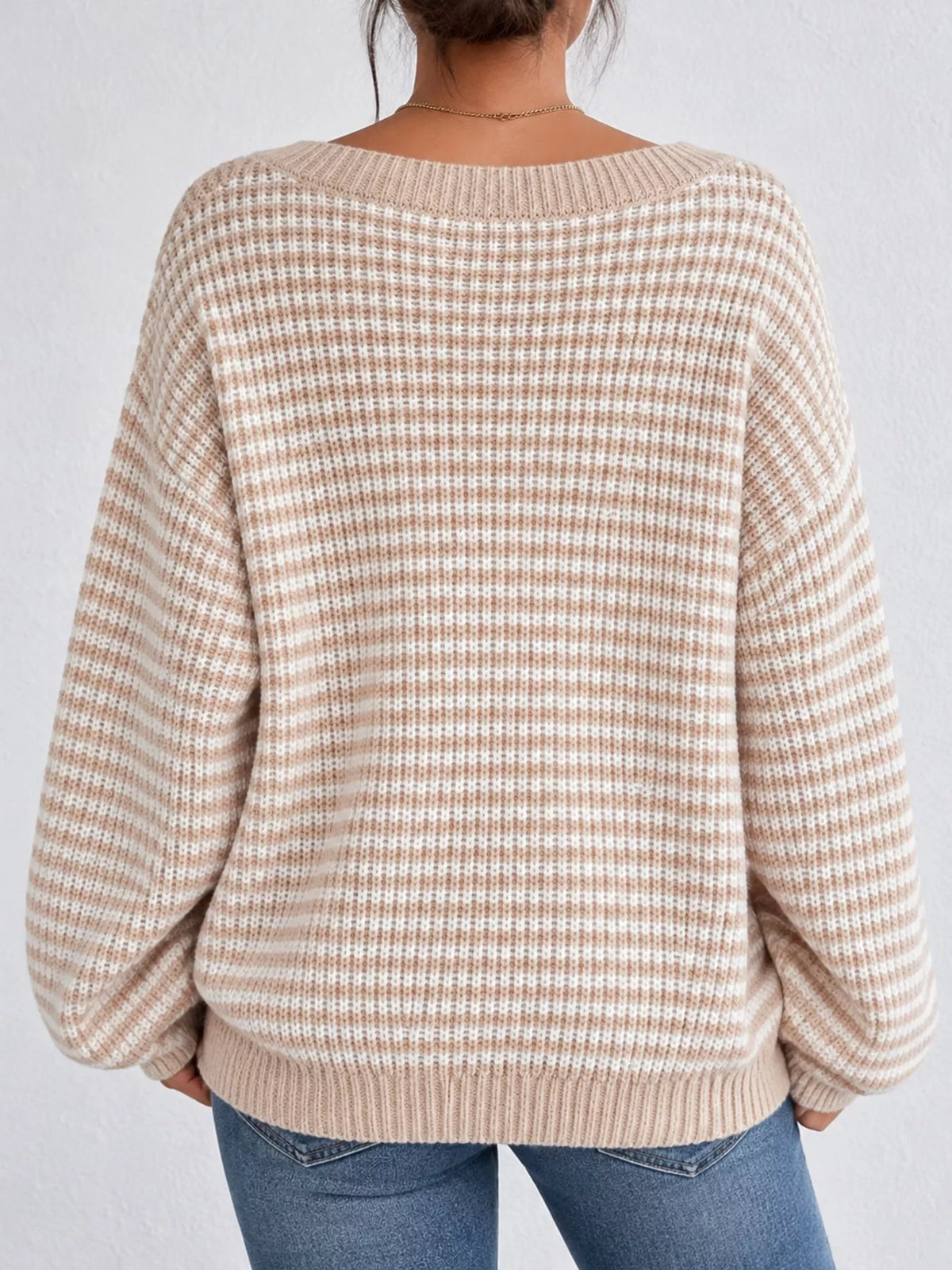 Beige and white striped knit boat neck sweater, back view
