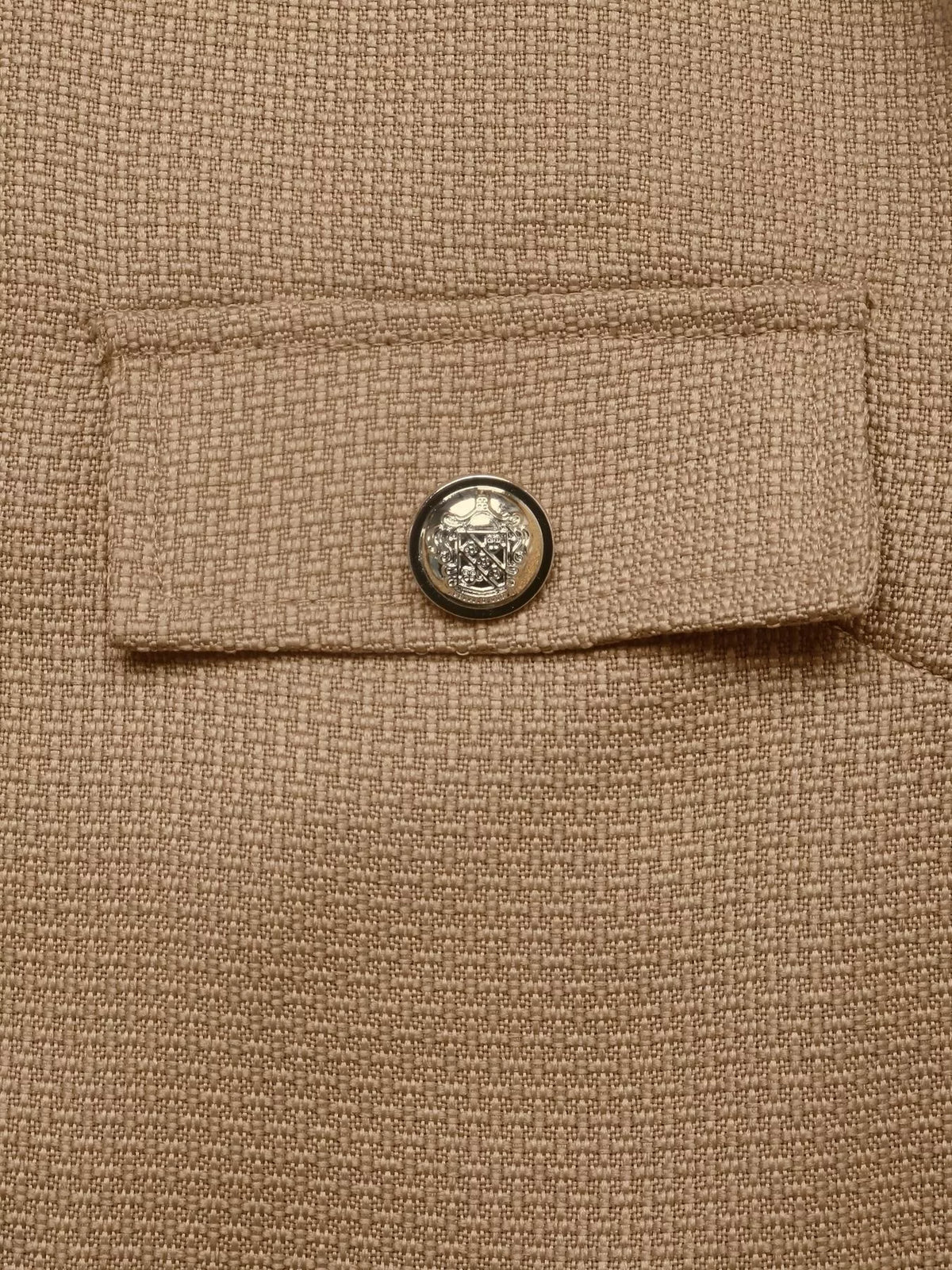 Tan textured cropped jacket with gold-tone buttons, buttoned flap detail