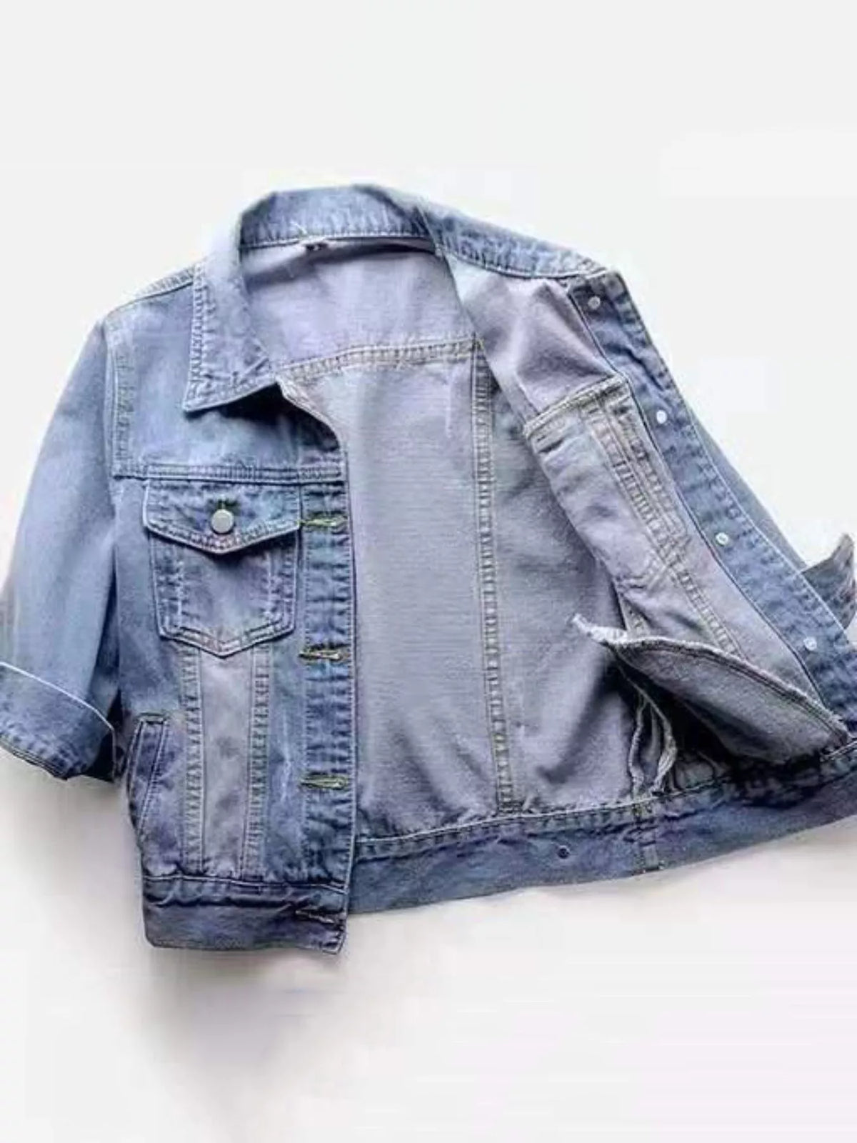 Light blue washed denim mid-sleeve jacket, open front showing inner seams and button placket