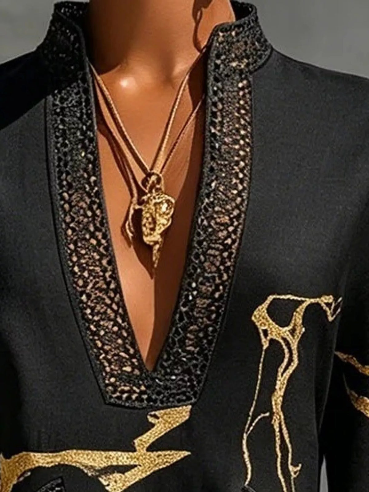 Black notched 3/4 sleeve mini dress, close-up of the neckline trim