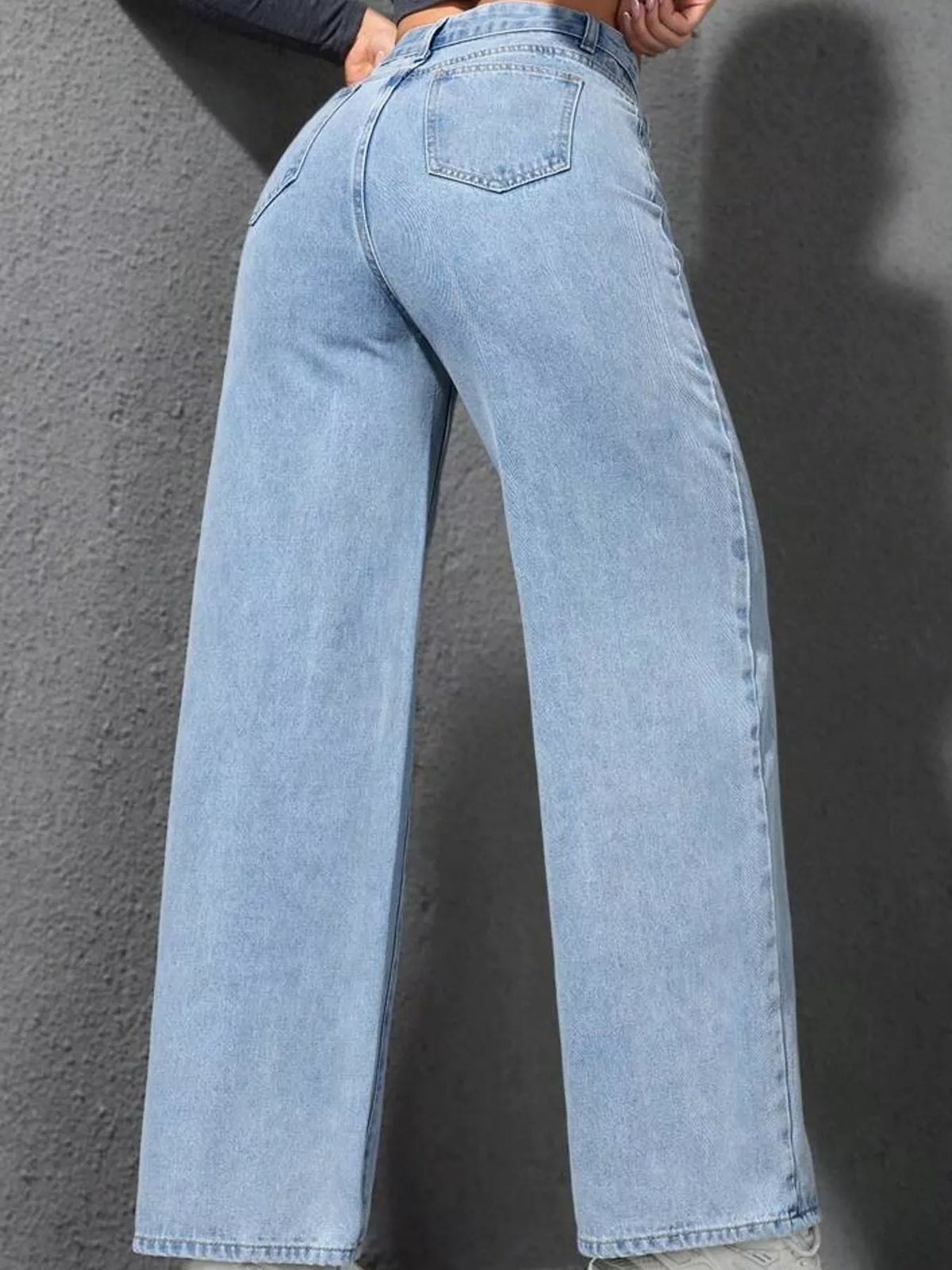 Light blue high waisted wide leg jeans, back view