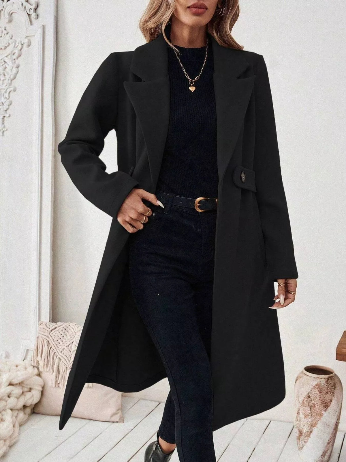Black lapel-collar longline coat, open front, hand at waist