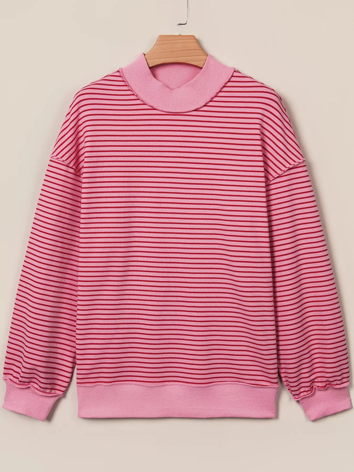 Pink and red striped striped color-block mock neck sweatshirt — front view