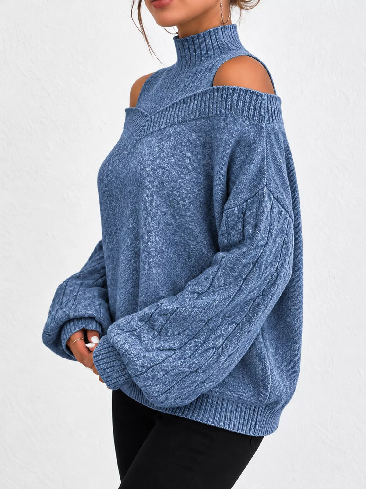 Blue cold shoulder mock neck cable knit sweater, side view