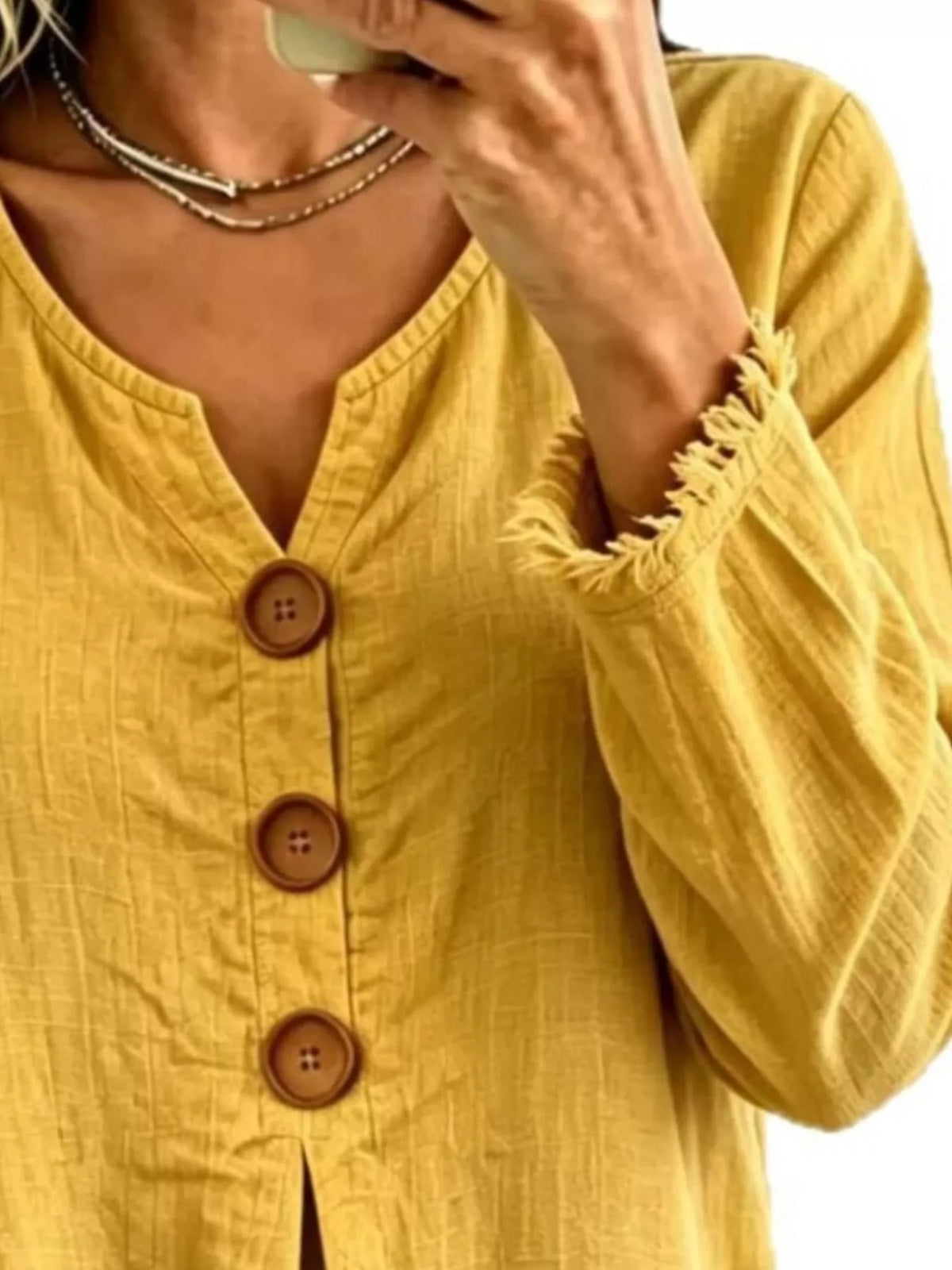 Yellow Frayed-Hem Long Sleeve Button-Front Blouse neckline, buttons, and fringe detail