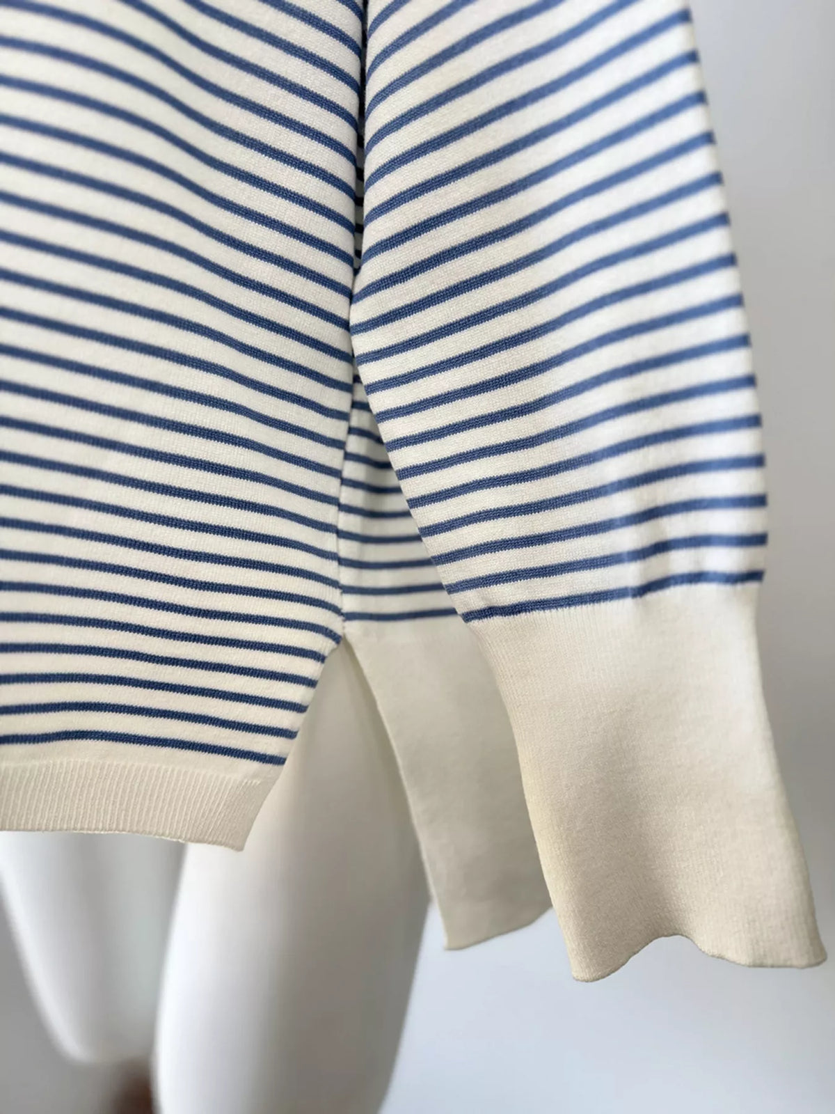Striped round-neck knit top in white and blue, cuff detail