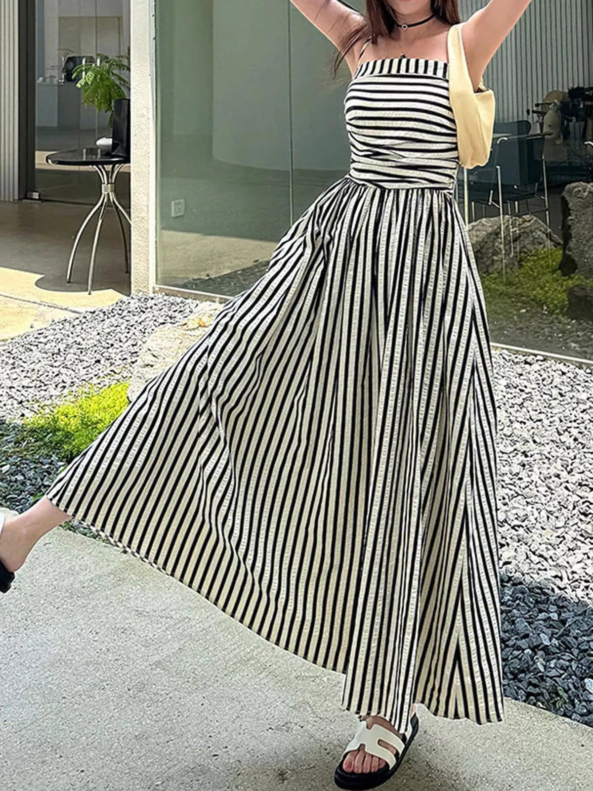 Black and white striped spaghetti strap maxi dress with gathered bodice and pockets