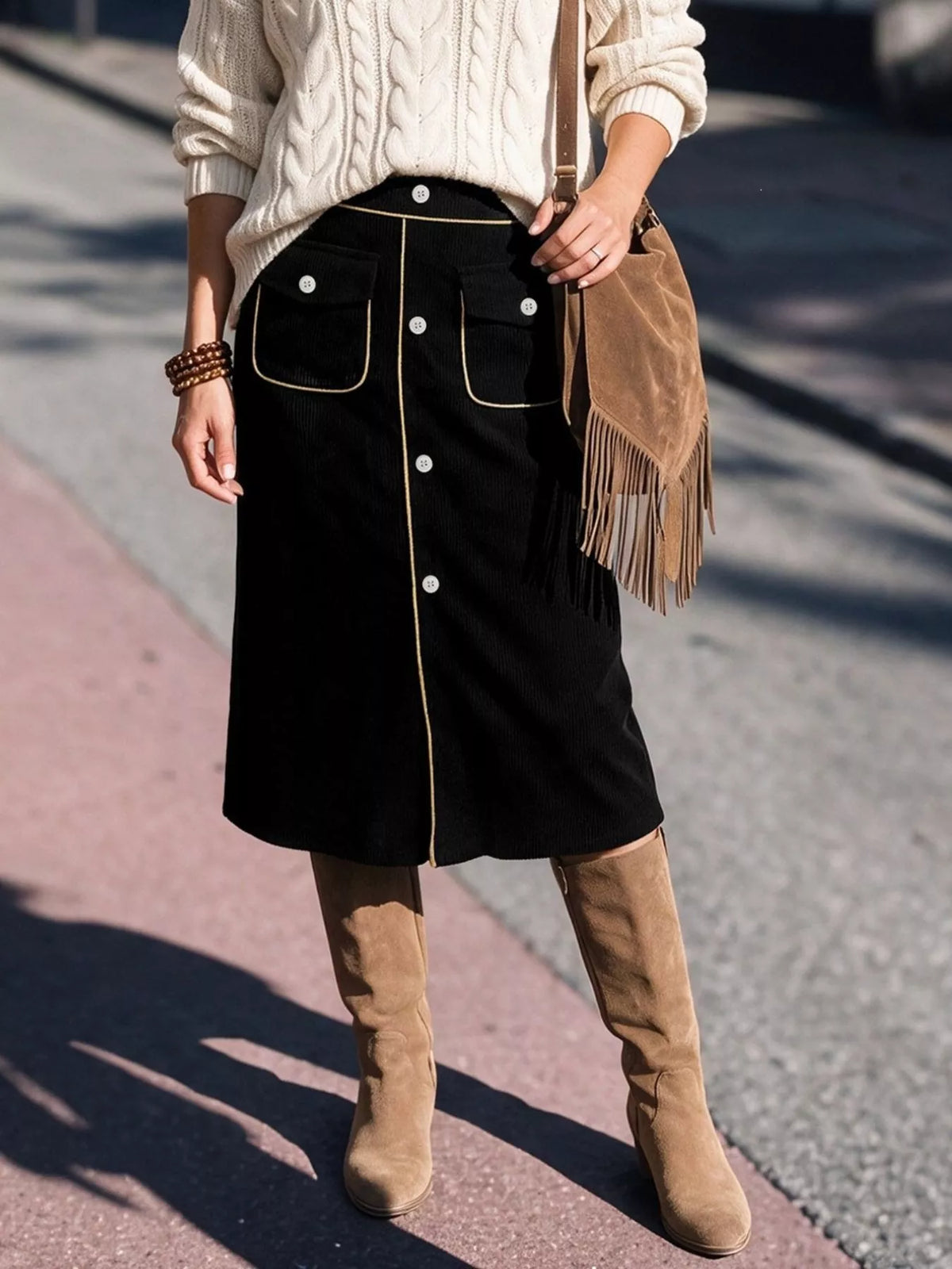 Black corduroy button-front midi skirt, front pocket view