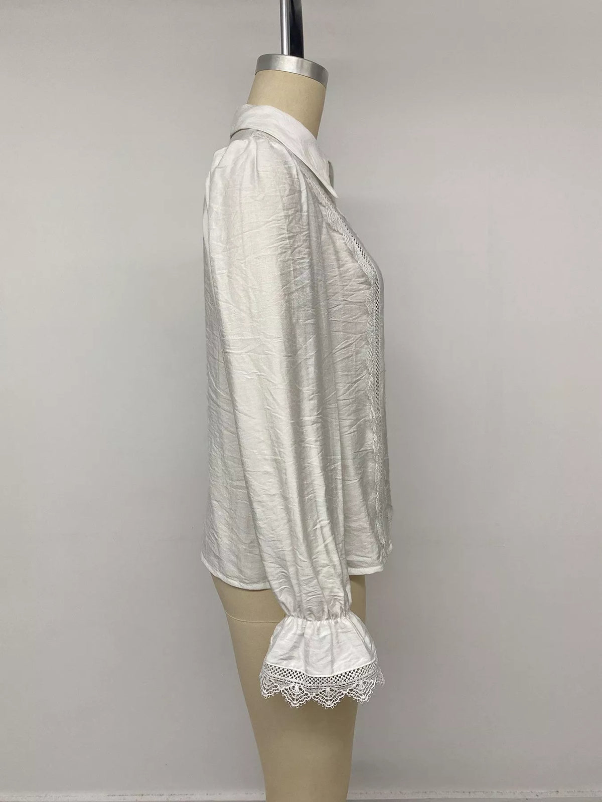 White lace-trimmed button-down shirt, side on mannequin
