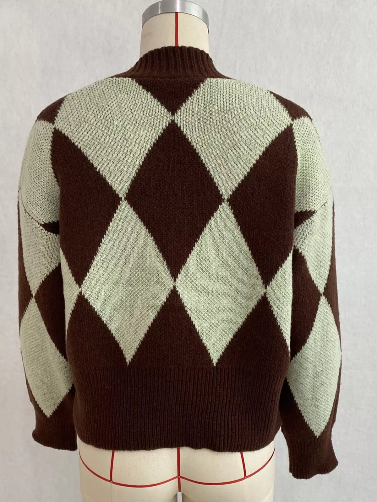 Brown and green argyle v-neck button-front cardigan, back on dress form.