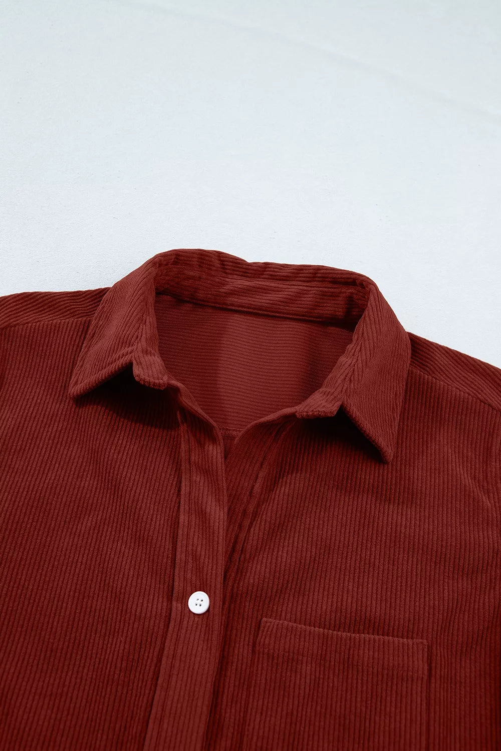 Rust corduroy button-down shirt, collar and chest pocket detail