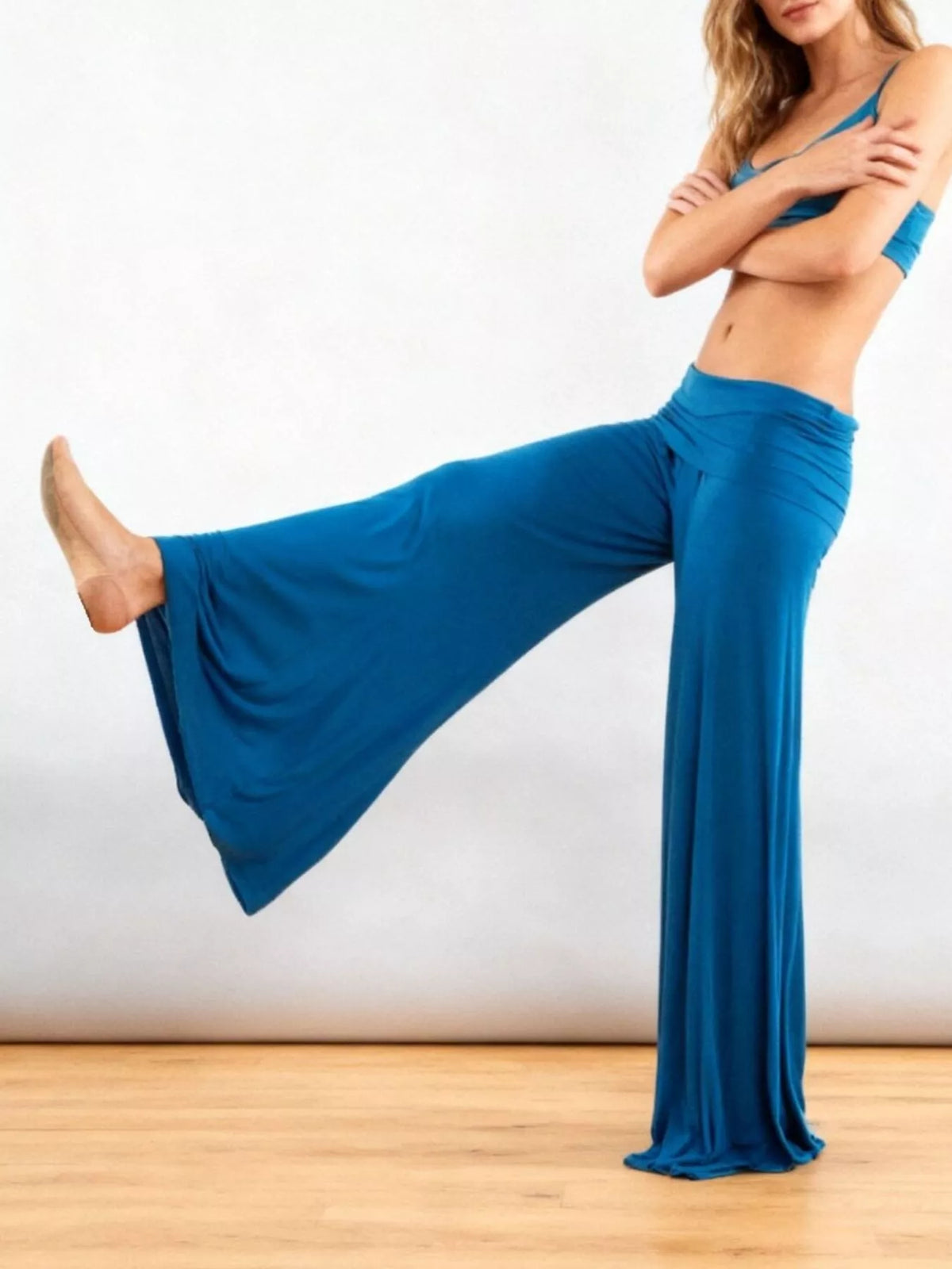 Blue fold-over wide-leg pants, side view with extended leg