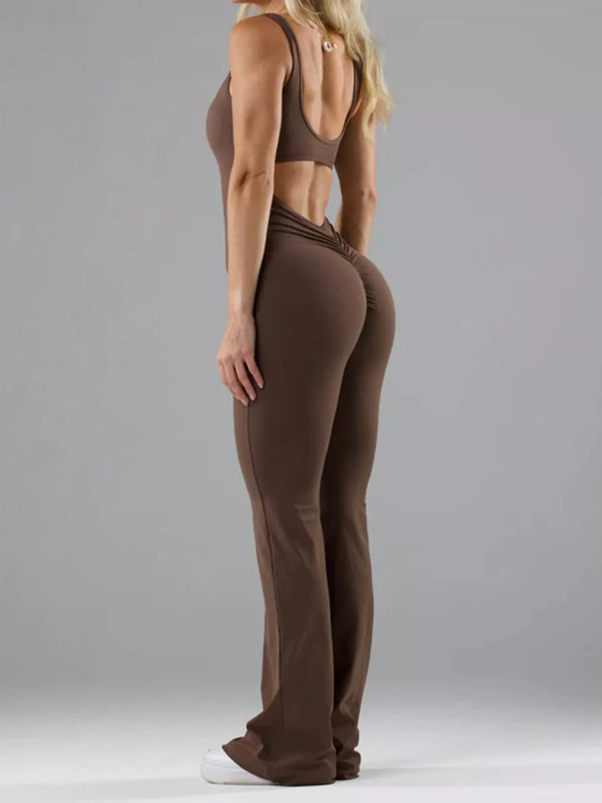 Brown scoop-neck flared-leg active jumpsuit, back cutout view.