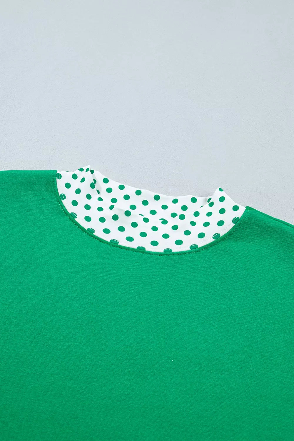 Green sweatshirt and shorts set with polka-dot trim, front neckline detail