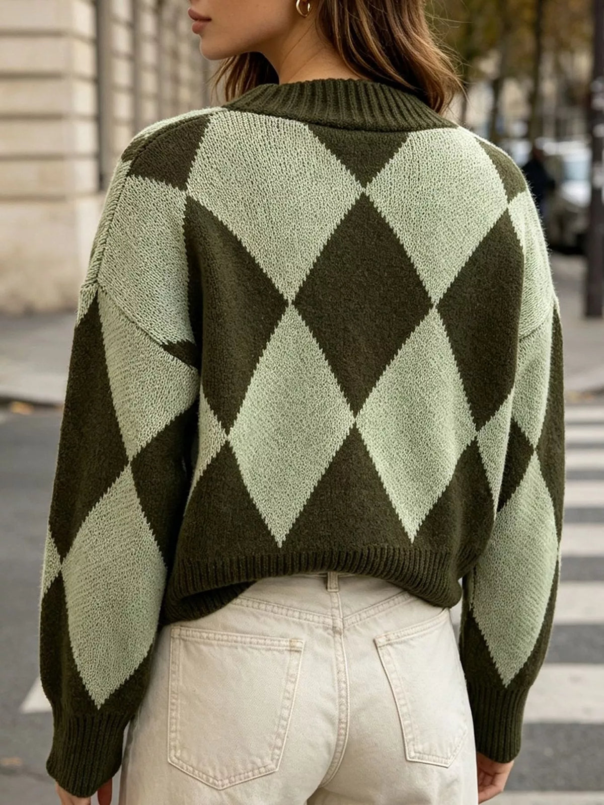 Green argyle v-neck button-front cardigan, back view with white pants.