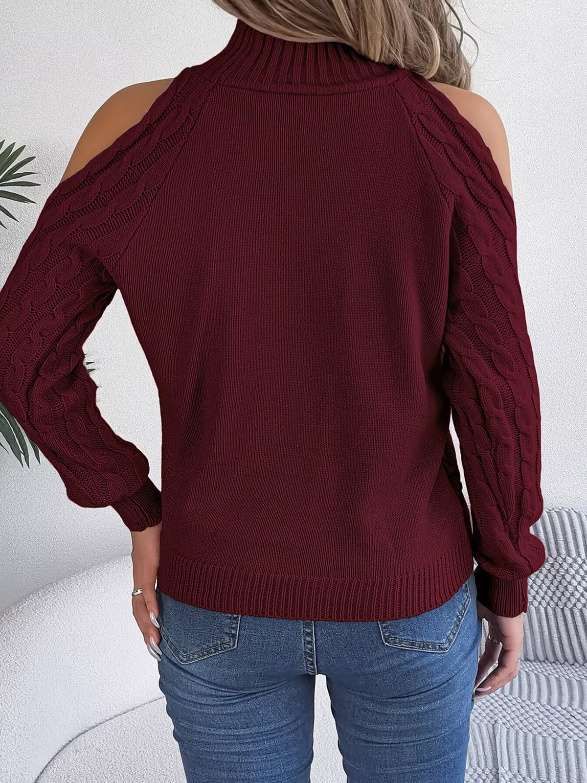 Burgundy cold-shoulder cable-knit sweater, back view.