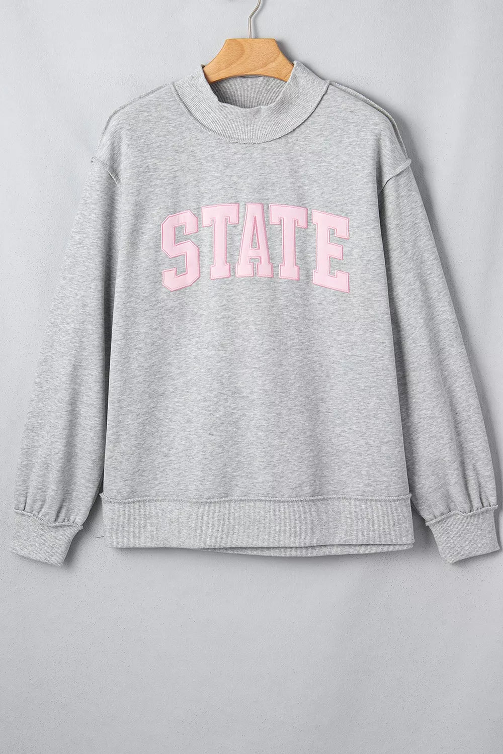 STATE Graphic Exposed Seam Mock Neck Sweatshirt in gray, hanger front view