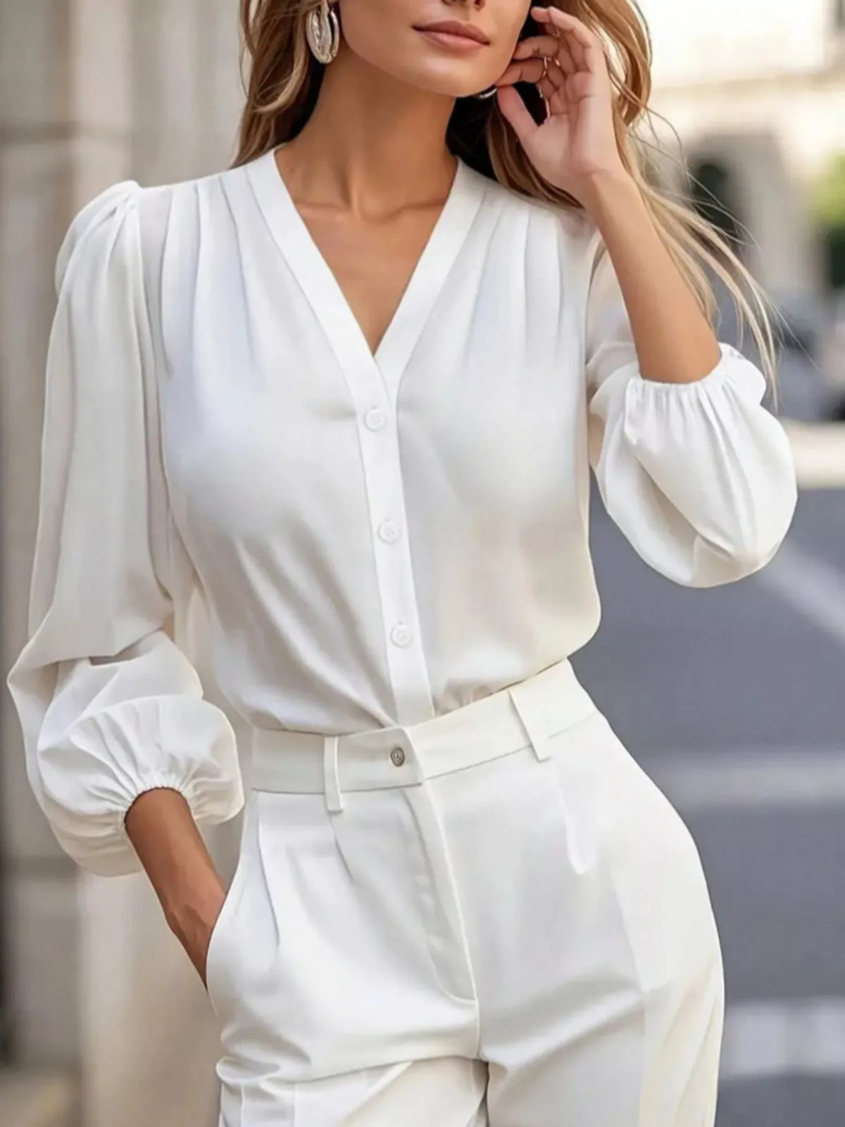 V-neck puff-sleeve button-down shirt in white, raised-arm front view