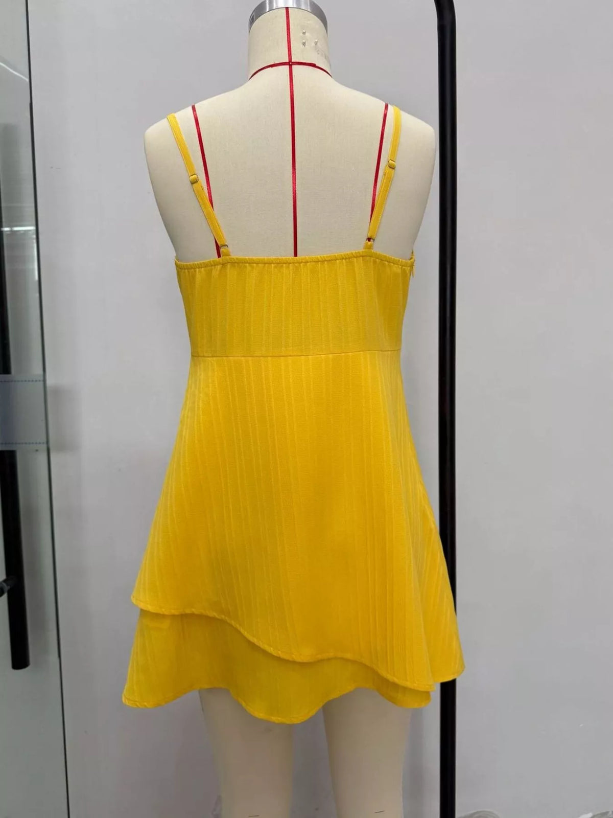Yellow spaghetti strap bow-front layered mini dress, back view