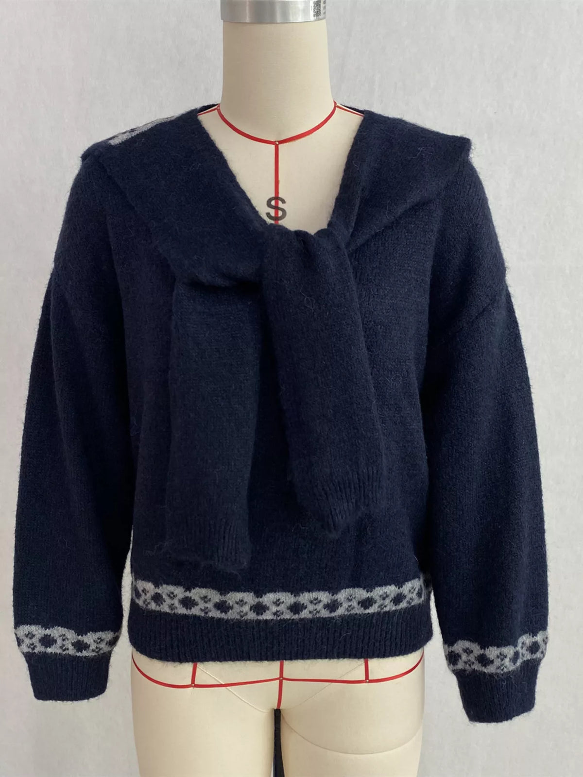 Navy scarf-detail dropped-shoulder sweater, front on dress form.