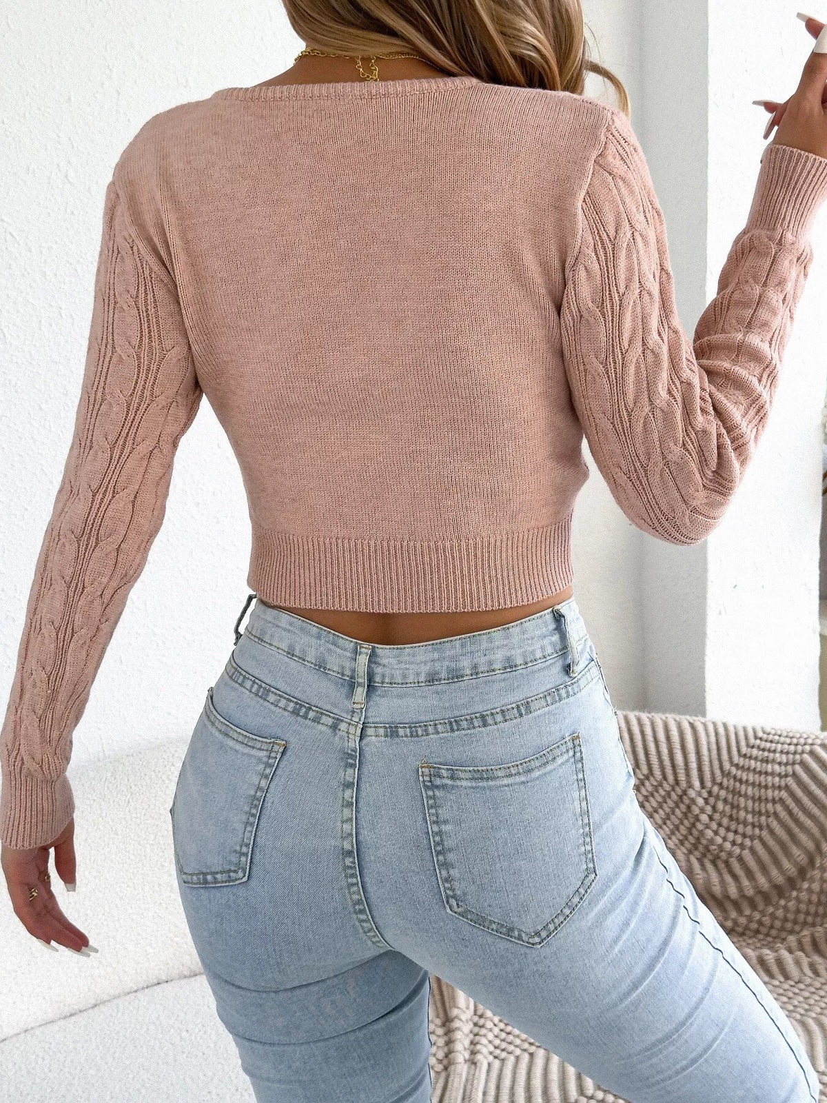 Pink half-zip cable knit sweater, back view