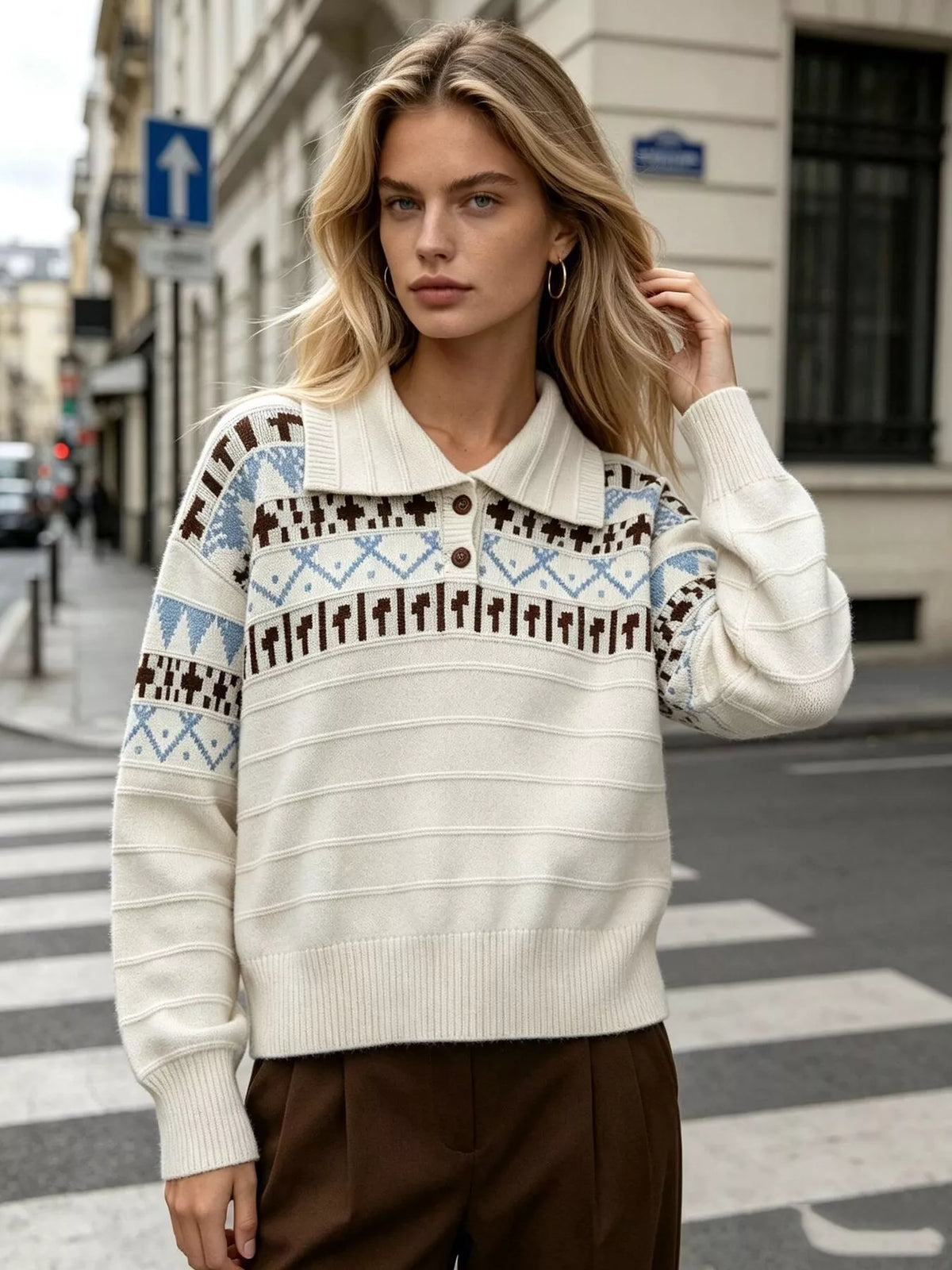 Cream fair isle polo-collar sweater, front with raised hand.