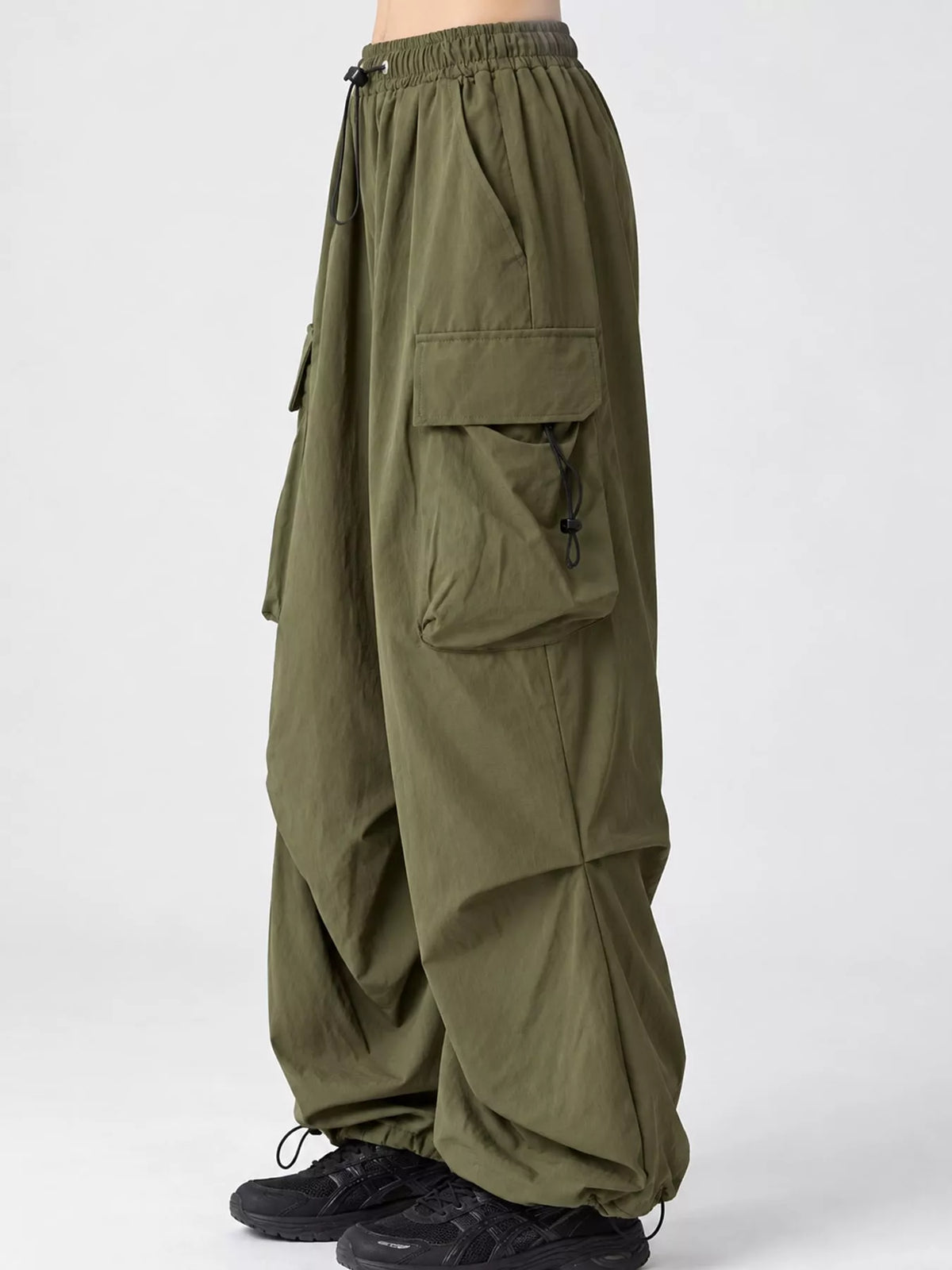 Green drawstring cargo pants, side view