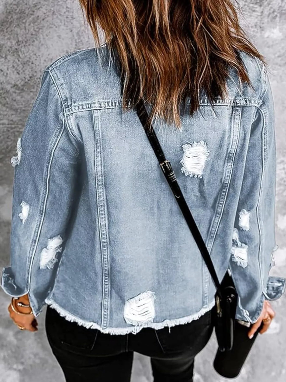 Women's Distressed Raw Hem Denim Jacket in light blue — back view