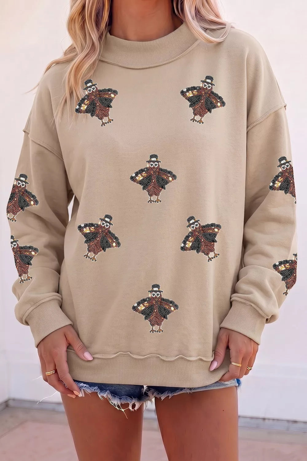Sequin turkey mock-neck exposed-seam sweatshirt
