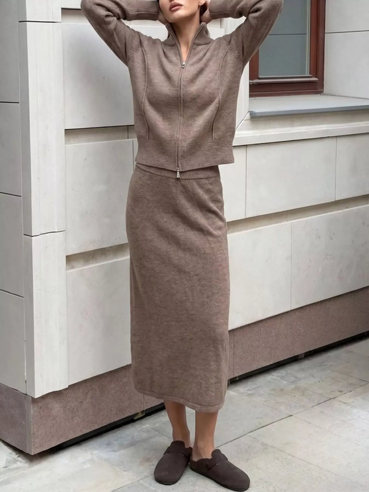Zip-up cardigan and midi skirt knit set in taupe, raised-arms view