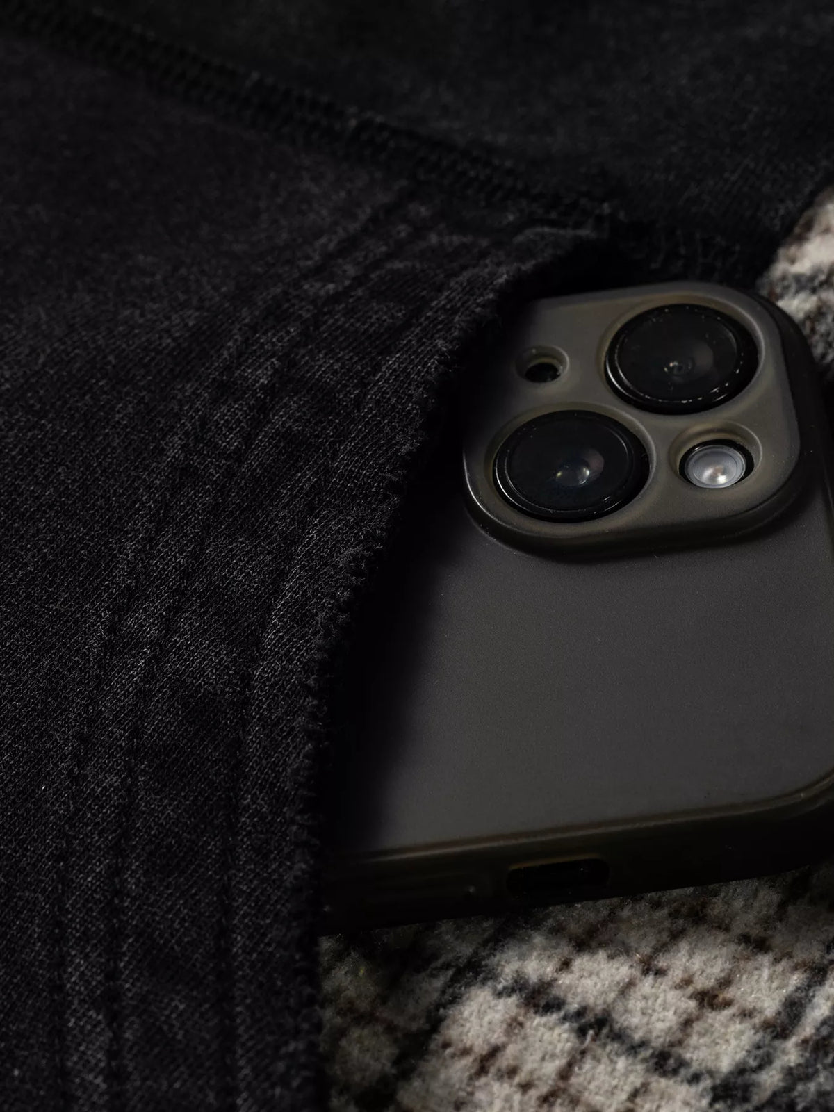 Plaid-sleeve hoodie, black kangaroo pocket close up