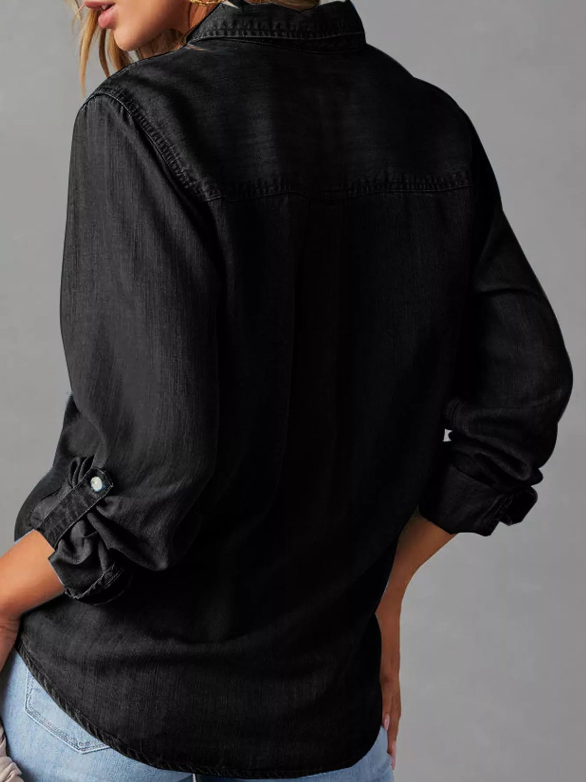 Black button-down denim shirt, back view