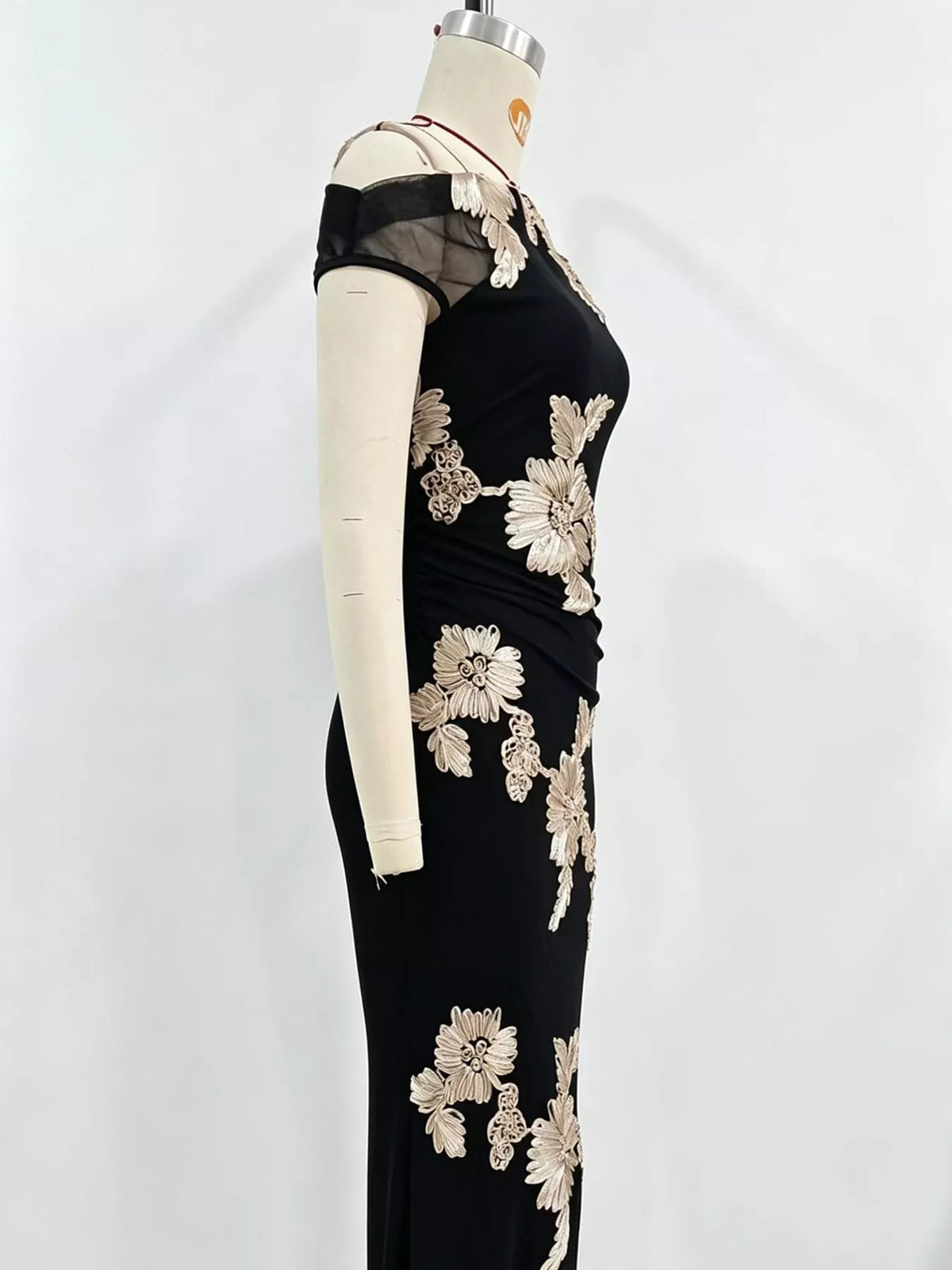 Black floral one-shoulder maxi dress, side on mannequin
