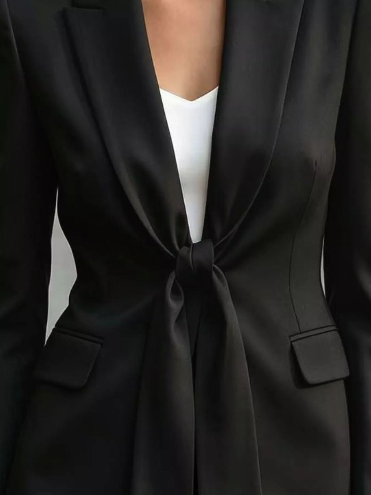 Tie-front lapel collar blazer in black, front tie and pocket detail