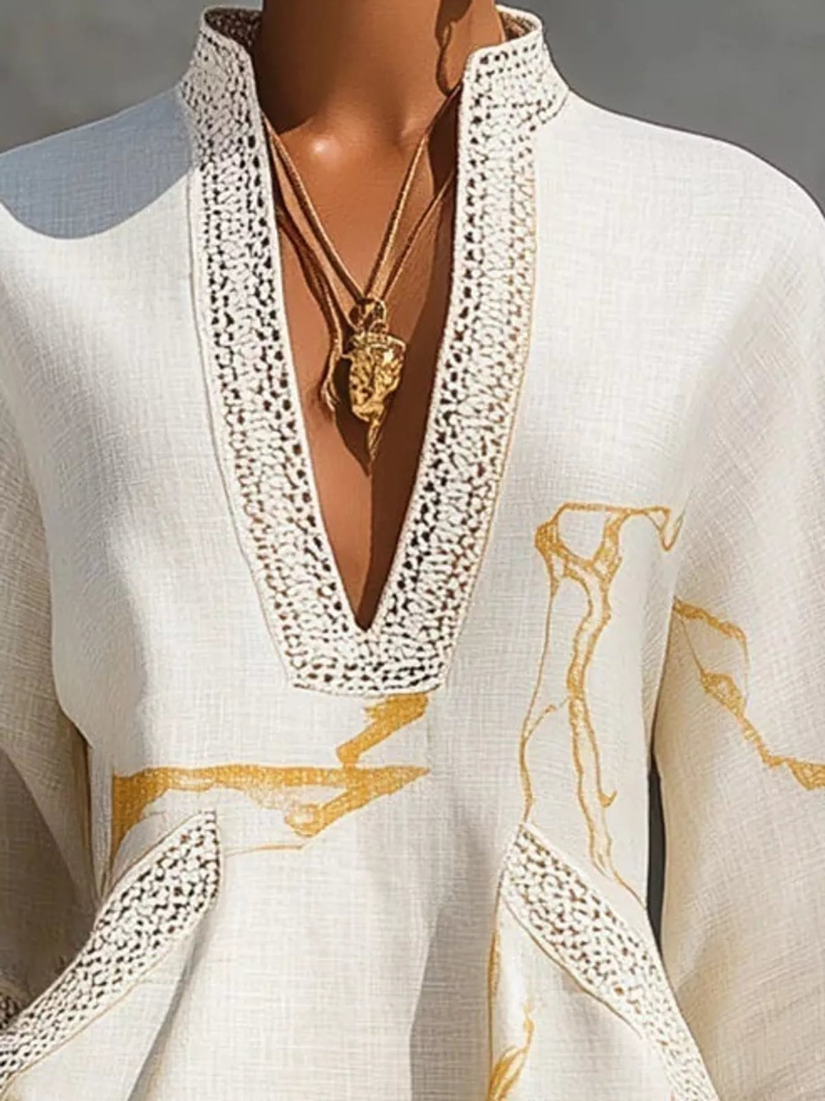 White notched 3/4 sleeve mini dress, close-up of the trimmed neckline