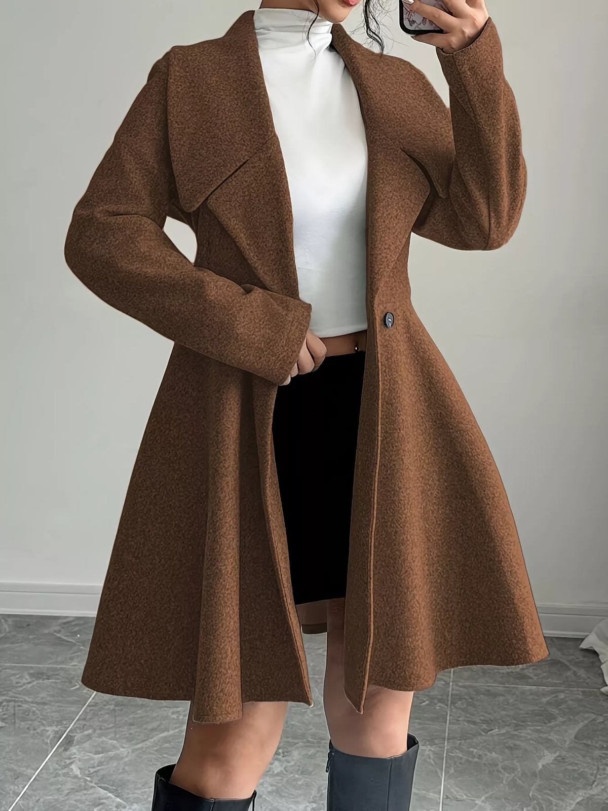 Brown double-breasted flared coat, open-front view with arm bent