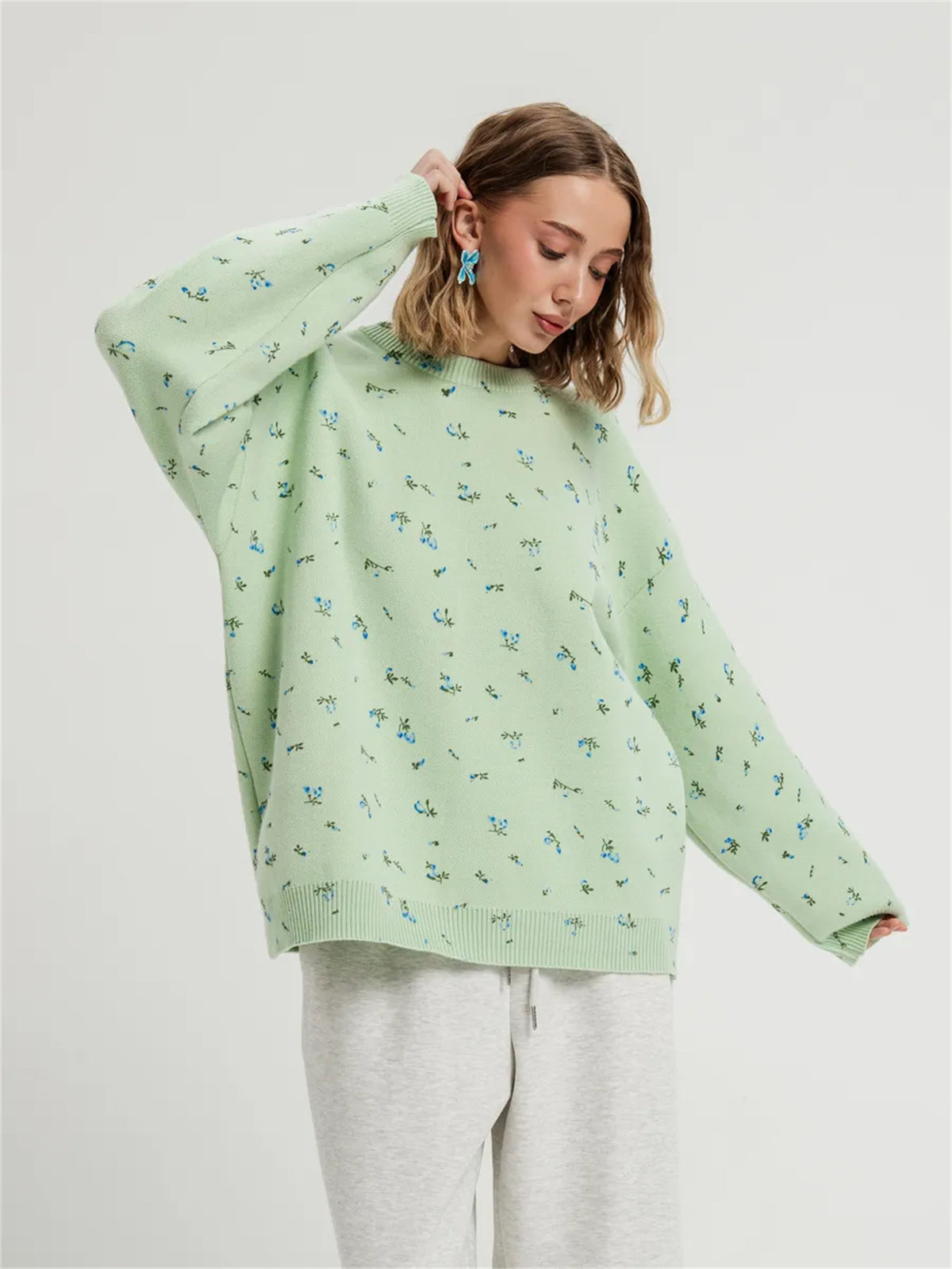 Green floral dropped-shoulder oversized sweater, front view.