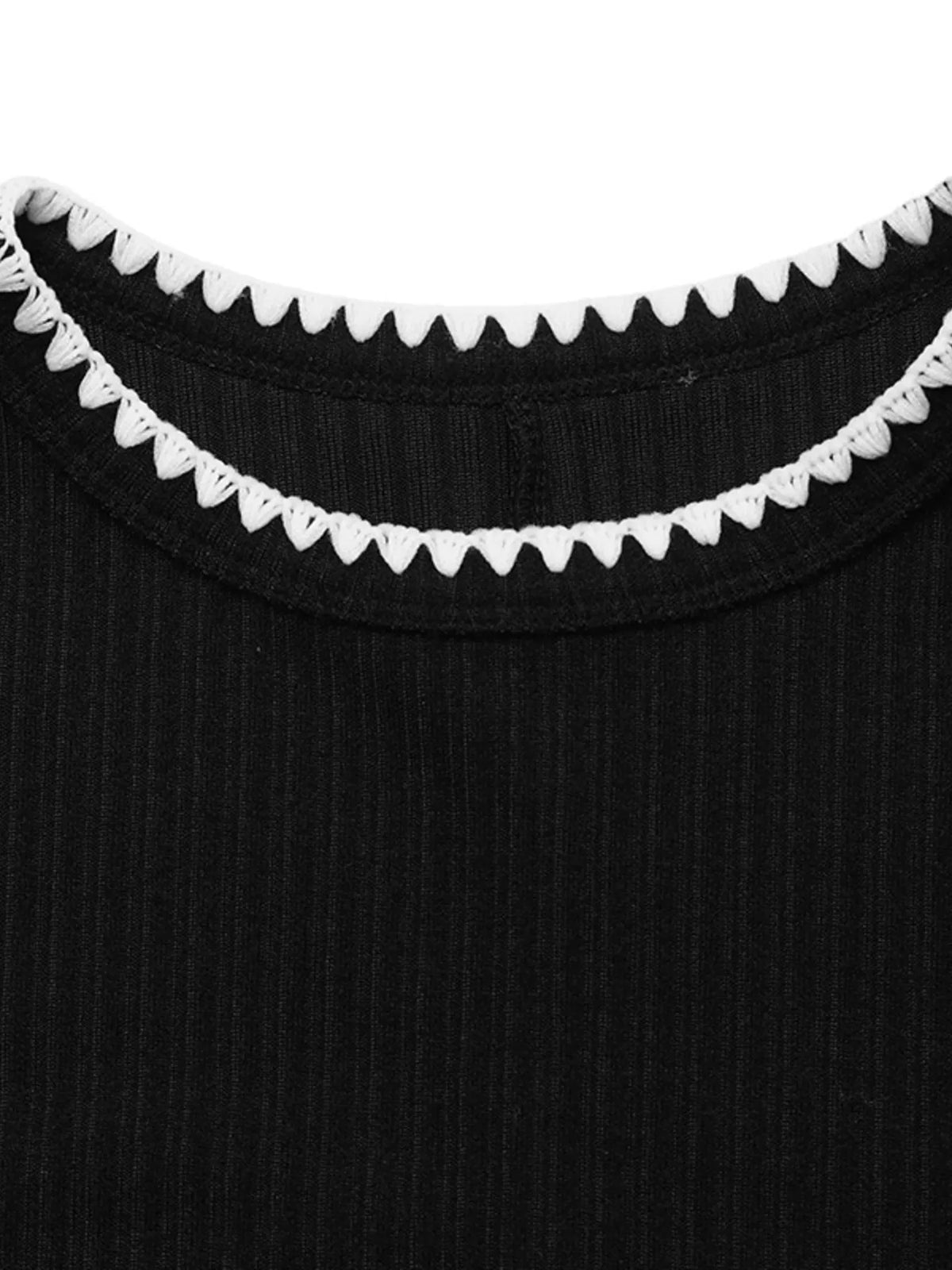 Black ribbed knit dress with white contrast trim, neckline trim detail