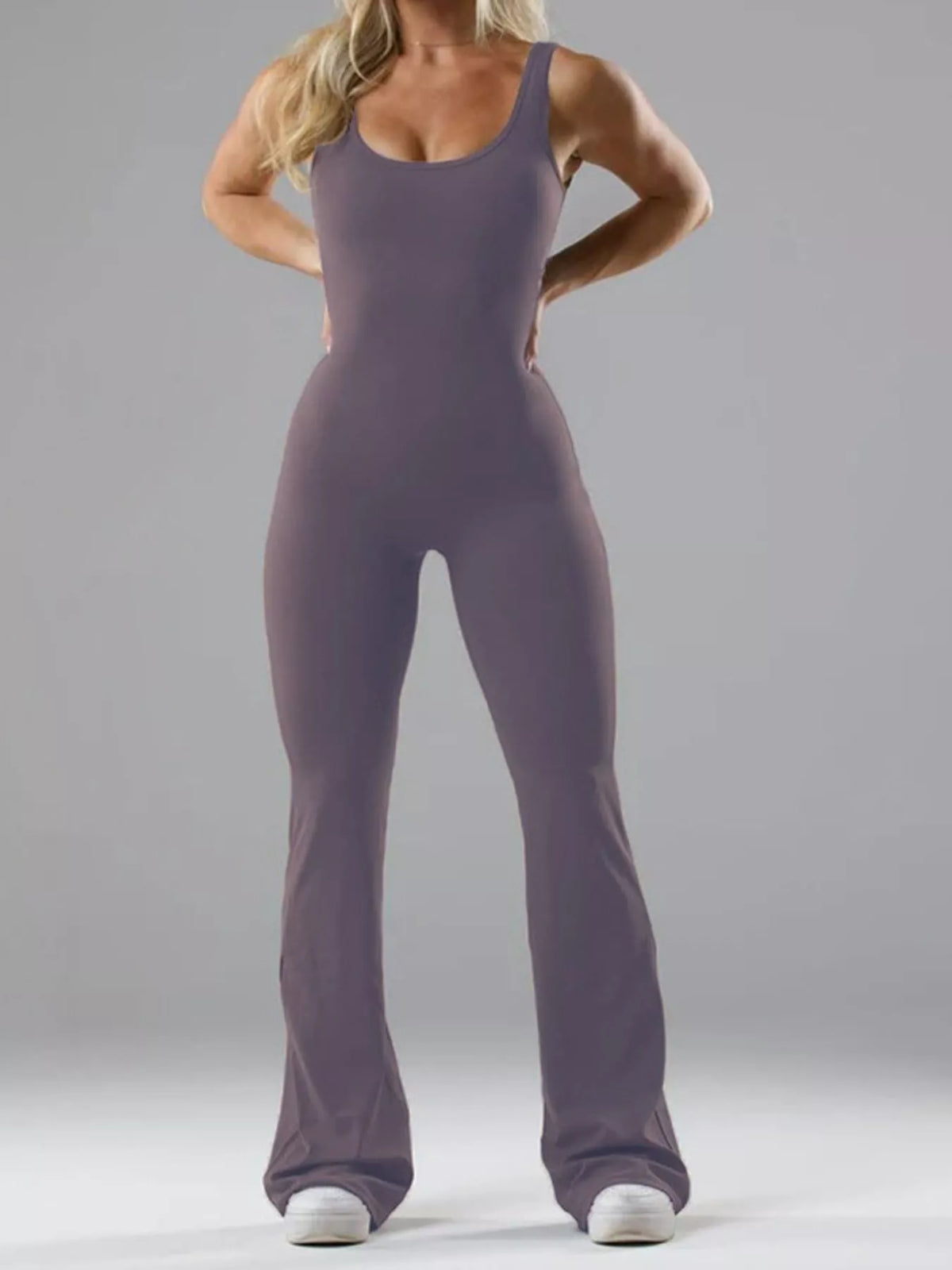 Purple scoop-neck flared-leg active jumpsuit, full front view.