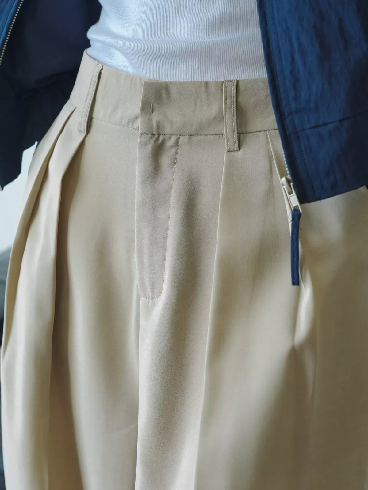 Women's High-Waisted Pleated Wide-Leg Pants in beige — waist detail view